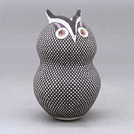 A polychrome owl figure decorated with a checkerboard tiny square and geometric design, click or tap to see a larger version