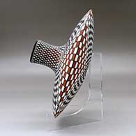 A polychrome low shouldered jar with a squarish neck and rim and decorated with a stylized checkerboard and geometric design, click or tap to see a larger version