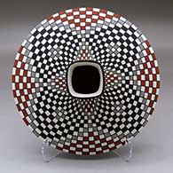 A polychrome low shouldered jar with a squarish neck and rim and decorated with a stylized checkerboard and geometric design
 by Paula Estevan of Acoma