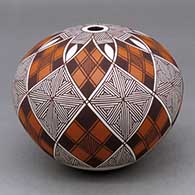 A polychrome seed pot decorated with an eight panel stylized checkerboard, fineline and geometric design
 by Robert Patricio of Acoma