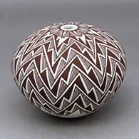 A black on white seed pot decorated with a lightning bolt, fineline and geometric design
 by Robert Patricio of Acoma