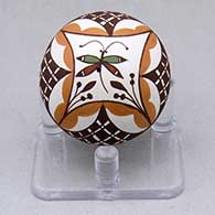 A miniature polychrome seed pot decorated with a dragonfly, flower and geometric design
 by Diane Lewis of Acoma
