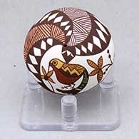 A miniature polychrome seed pot decorated with a hummingbird, flower, fineline and geometric design
 by Diane Lewis of Acoma