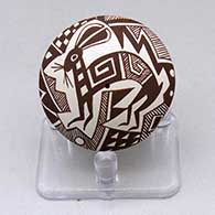 A miniature black on white seed pot decorated with a Mimbres rabbit, fineline and geometric design
 by Diane Lewis of Acoma