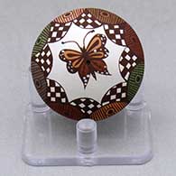 A miniature polychrome seed pot decorated with a butterfly, fineline, checkerboard and geometric design
 by Diane Lewis of Acoma
