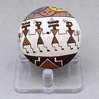 A miniature polychrome seed pot decorated with a pueblo dancer, fineline and geometric design
 by Diane Lewis of Acoma