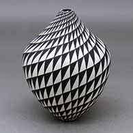 A black on white vase decorated with a spiral mesa geometric design
 by Sandra Victorino of Acoma