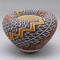A polychrome jar with an Infinity rim and decorated with a four panel lightning bolt, kiva step and tiny squares geometric design
 by Frederica Antonio of Acoma