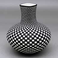 A black on white vase with a square neck and decorated with a checkerboard geometrid design
 by Paula Estevan of Acoma