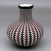 A polychrome vase with a pie crust rim, decorated with a geometric design
 by Paula Estevan of Acoma