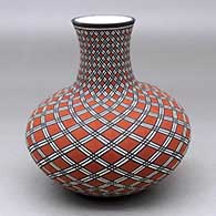 A polychrome vase decorated with a stylized spiral geometric design
 by Paula Estevan of Acoma