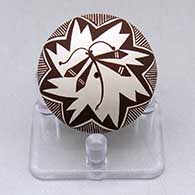 A miniature black on white seed pot decorated with a dragonfly, fineline and geometric design
 by Diane Lewis of Acoma