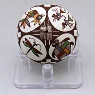 A miniature polychrome seed pot decorated with a women dancer, parrot, turtle, dragonfly, fineline and geometric design
 by Diane Lewis of Acoma