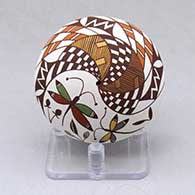 A polychrome seed pot decorated with a dragonfly, plant, rain cloud, fineline and geometric design
 by Diane Lewis of Acoma