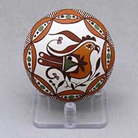 A polychrome seed pot decorated with a parrot, plant, rain cloud and geometric design
 by Diane Lewis of Acoma
