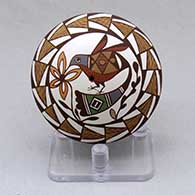 A polychrome seed pot decorated with a hummingbird, flower, fineline and geometric design
 by Diane Lewis of Acoma