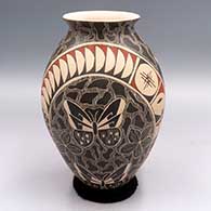 Polychrome jar with a flared lip and a sgraffito and painted butterfly and geometric design
 by Unknown of Mata Ortiz and Casas Grandes