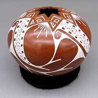 Red and white jar with a geometric cut opening and a sgraffito and painted geometric design
 by Angel Amaya of Mata Ortiz and Casas Grandes