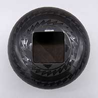 A black on black jar with a square geometric cut opening and a geometric design
 by Ruben Rodriguez of Mata Ortiz and Casas Grandes