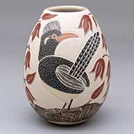 A polychrome jar decorated with a sgraffito-and-painted roadrunner, plant, leaf and flower design
 by Guadalupe Melendez of Mata Ortiz and Casas Grandes