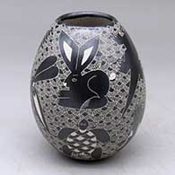 A black-on-white jar decorated with a sgraffito animal, bird, turtle, insect and geometric design
 by Alex Ortega of Mata Ortiz and Casas Grandes