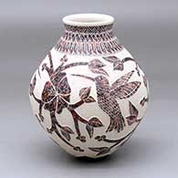 A polychrome jar decorated with a hummingbird, vine, flower and geometric design
 by Lupita Quezada of Mata Ortiz and Casas Grandes