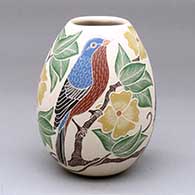 A polychrome jar decorated with a sgraffito and painted bird, branch, leaf and flower design
 by Guadalupe Melendez of Mata Ortiz and Casas Grandes