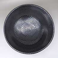 A large, open glossy black bowl decorated inside and out with a spiraling tooled geometric design
 by Reynaldo Quezada of Mata Ortiz and Casas Grandes