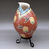 A polychrome jar with a kiva-step cut opening and decorated with a sgraffito hummingbird, flower and mesh geometric design
 by Vidal Corona of Mata Ortiz and Casas Grandes