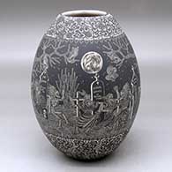 A black on white jar decorated with a sgraffito Night of the Dead at the Cemetery with Native Americans and geometric design
 by Hector Javier Martinez of Mata Ortiz and Casas Grandes
