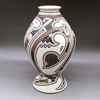 Click for a larger view A polychrome jar decorated with a lightly carved and painted Paquime serpent, sickle and geometric design, with a custom matching stand
 by Lazaro Ozuna of Mata Ortiz and Casas Grandes