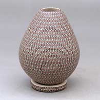A polychrome jar decorated with bands of tiny geometric designs with a custom matching stand
 by Karla Lopez Cota of Mata Ortiz and Casas Grandes