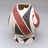 Click for a larger view A polychrome jar with a geometric cut opening and decorated with a geometric design, plus a custom matching stand
by Elias Pena of Mata Ortiz and Casas Grandes