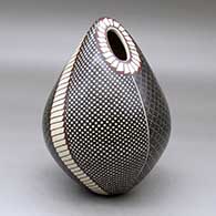 A polychrome ovoid seed pot decorated with a four-panel tiny square and geometric design
 by Luz Elva Gutierrez of Mata Ortiz and Casas Grandes