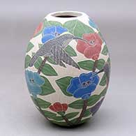 Click for a larger view A polychrome jar decorated with a sgraffito and painted bird, butterfly, flower, branch and leaf design
by Karla Flores of Mata Ortiz and Casas Grandes