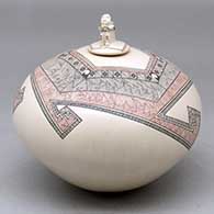 A polychrome jar decorated with a fineline and geometric design and a seated matachine on the lid
 by Carla Martinez of Mata Ortiz and Casas Grandes