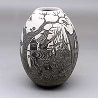 A black on white jar decorated with a sgraffito Day of the Dead at the cemetery design
 by Hector Javier Martinez of Mata Ortiz and Casas Grandes