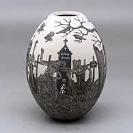 A black on white jar decorated with a sgraffito Day of the Dead at the cemetery design
 by Hector Javier Martinez of Mata Ortiz and Casas Grandes
