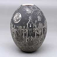 A black on white jar decorated with a sgraffito Night of the Dead under the full moon design
 by Hector Javier Martinez of Mata Ortiz and Casas Grandes