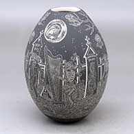 A black on white jar decorated with a sgraffito Night of the Dead at the cemetery design
 by Hector Javier Martinez of Mata Ortiz and Casas Grandes