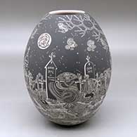 A black on white jar decorated with a sgraffito Night of the Dead at the cemetery design
 by Hector Javier Martinez of Mata Ortiz and Casas Grandes