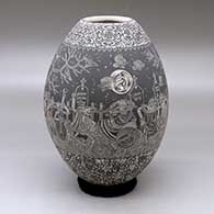 A black on white jar decorated with a sgraffito Night of the Dead at the cemetery and geometric design
 by Hector Javier Martinez of Mata Ortiz and Casas Grandes