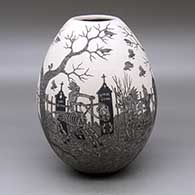 A black on white jar decorated with a sgraffito Day of the Dead at the cemetery design
 by Hector Javier Martinez of Mata Ortiz and Casas Grandes