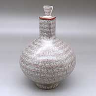 A square necked jar with a matching custom stand, decorated with a fineline spiral geometric design
 by Oralia Lopez of Mata Ortiz and Casas Grandes