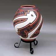Click for a larger view A polychrome jar decorated with a three panel lightly carved and painted sickle, bird element and geometric design
 by Tavo Silveira of Mata Ortiz and Casas Grandes
