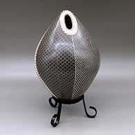 A polychrome egg-shaped seed pot decorated with a four panel checkerboard and geometric design
 by Luz Elva Gutierrez of Mata Ortiz and Casas Grandes