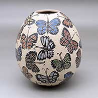 A polychrome jar decorated with a sgraffito and painted butterfly design
 by Ernesto Arras of Mata Ortiz and Casas Grandes