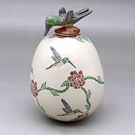 A polychrome jar decorated with a sgraffito and painted hummingbird, flower and vine design, plus a hummingbird lid
 by Luz Elva Gutierrez of Mata Ortiz and Casas Grandes
