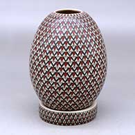 A polychrome jar with a matching custom stand, all decorated with a geometric design
 by Olga Arras of Mata Ortiz and Casas Grandes
