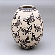 A polychrome jar decorated with a sgraffito and slipped butterfly and geometric design
 by Guadalupe Rodriguez of Mata Ortiz and Casas Grandes